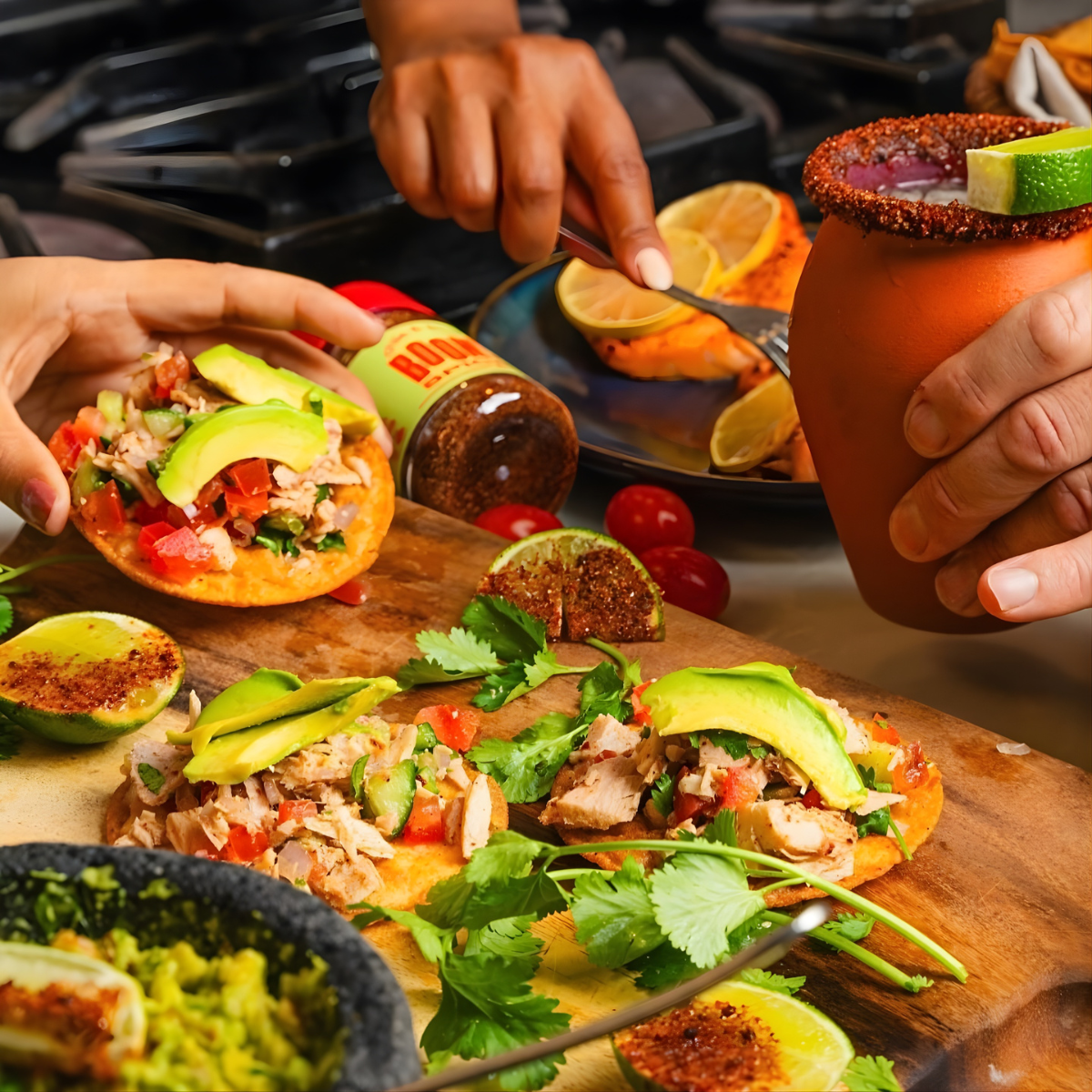 People enjoying a meal with tacos and drinks on a wooden board.