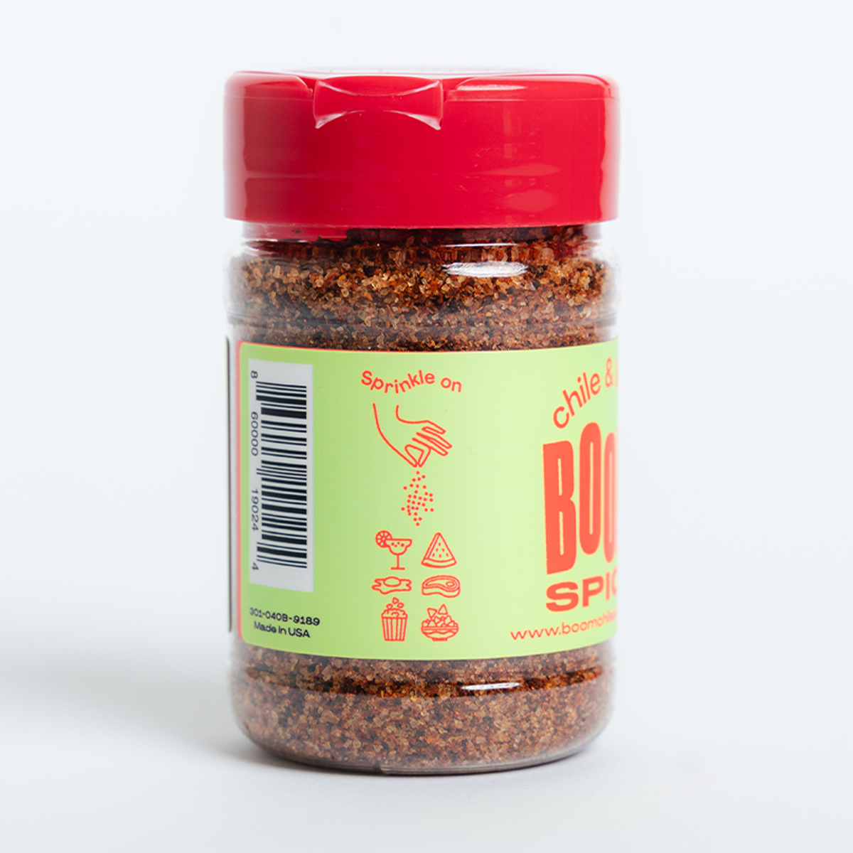 Jar of chili powder with a red lid on a white background