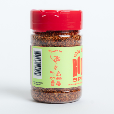 Jar of chili powder with a red lid on a white background